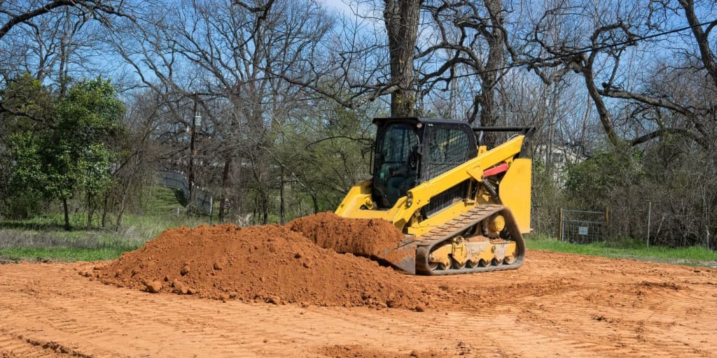 Brand-less compact track loader moving dirt