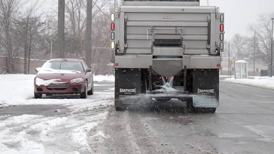 Truck spreading salt on a street.