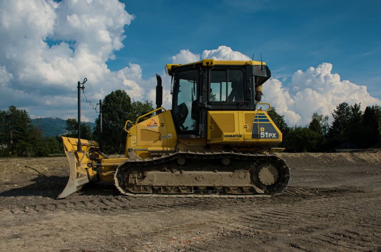 Dozer equipment machine moving dirt on construction site
