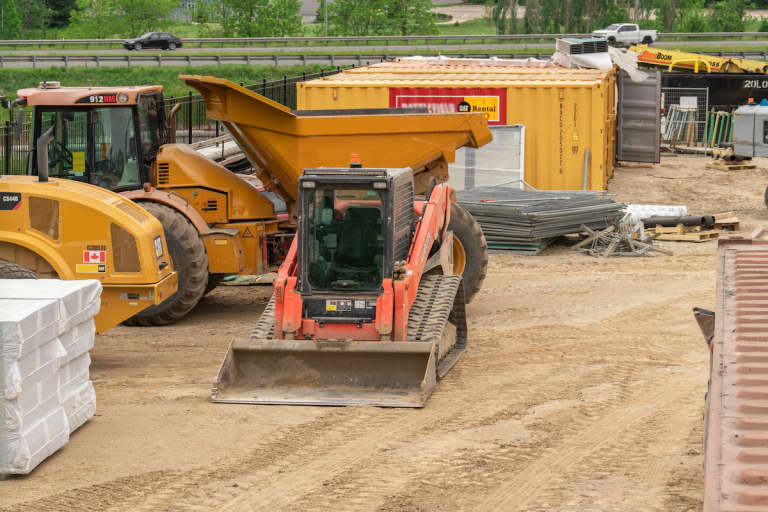 Skid steer rental parked on a construction site